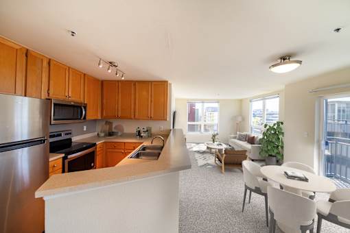 A kitchen with wooden cabinets and a white counter.