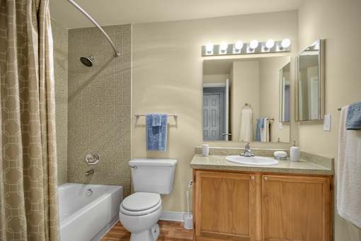 A bathroom with a toilet, sink, and shower.