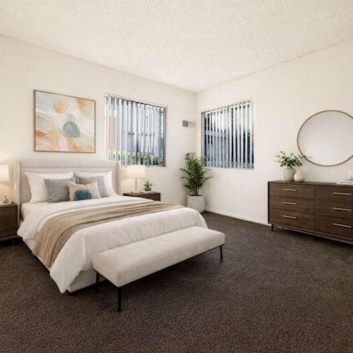 bedroom with bed, brown carpet and windows
