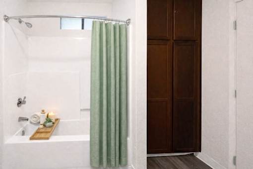 photo of bathroom bath tub with green curtain