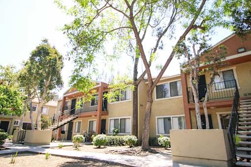 Apartment complex with trees in front.