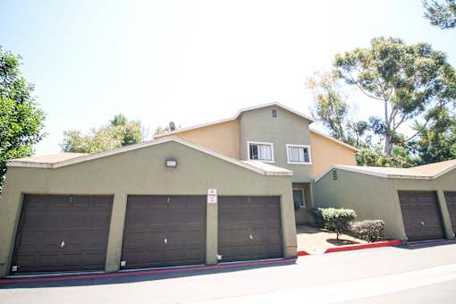 A two-story house with a garage and a driveway.