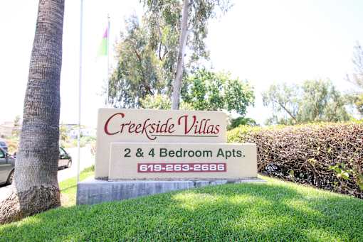 A sign for Creekside Villas 2 & 4 Bedroom Apts.