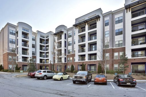 exterior apartment building with parking lot on sunny day  at The Brookhaven Collection, Atlanta, 30329