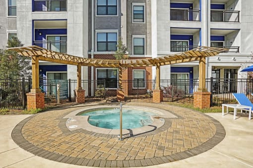 hot tub area and apartment building on sunny day  at The Brookhaven Collection, Atlanta