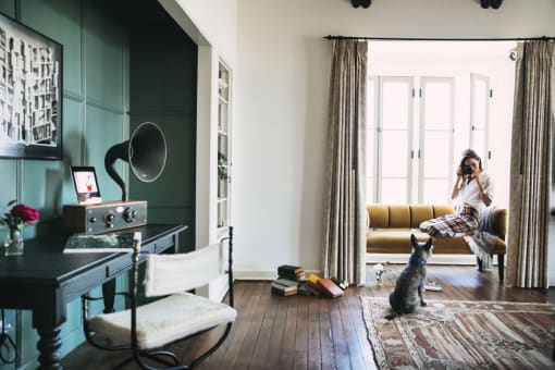 woman dog and old school record player  - Villa Carlotta  at Villa Carlotta – Furnished Apartments, Los Angeles, CA