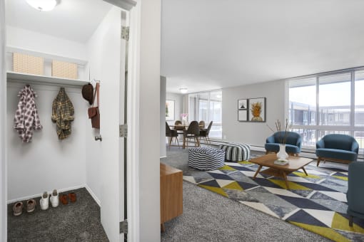 a living room with white walls and gray carpet