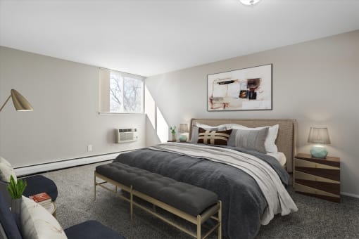 a bedroom with a bed and a chair in a 555 waverly unit