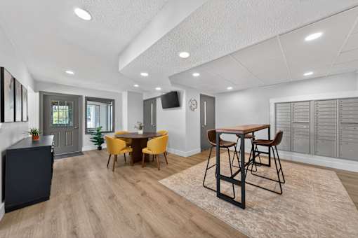A modern dining room with a wooden table and chairs.