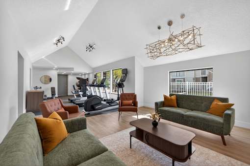 A living room with a green couch and a wooden coffee table.