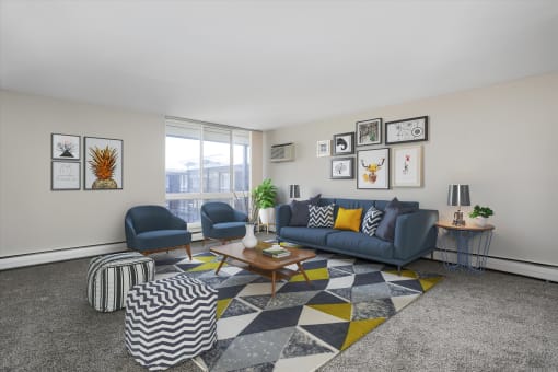 an open living room with a blue couch and two blue chairs and a coffee table with a