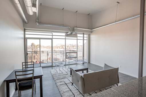 A room with a table and chairs and a couch.