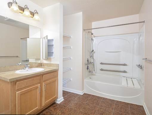 a bathroom with a shower and a sink and a mirror