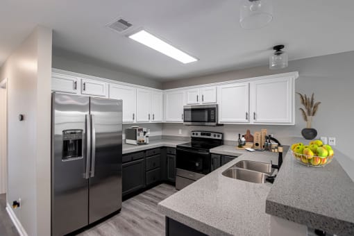 a kitchen with stainless steel appliances and granite counter tops