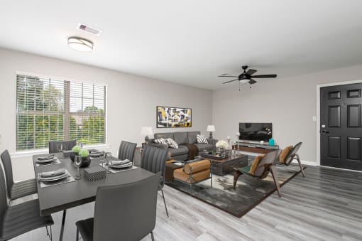 a living room and dining room with a table and chairs