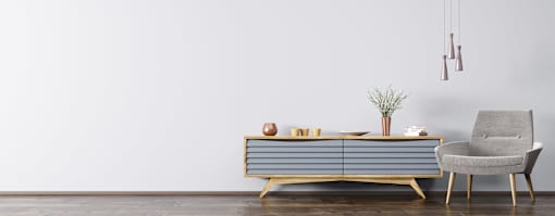 a sideboard in a living room with a white wall