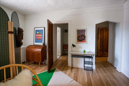 a living room with a dresser and a mirror in it