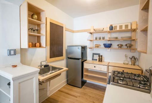 a kitchen with a sink and a stove and a refrigerator