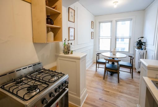 a white room with a stove and some windows