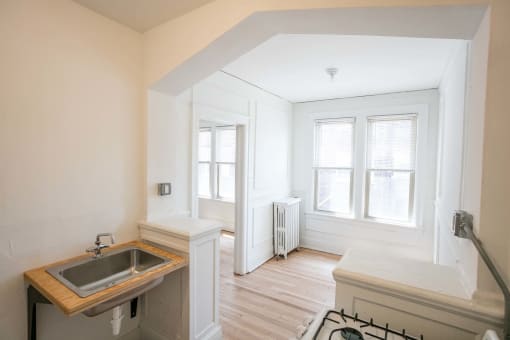 a small kitchen with a sink and a window