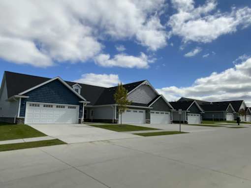 A row of houses with garages in front.