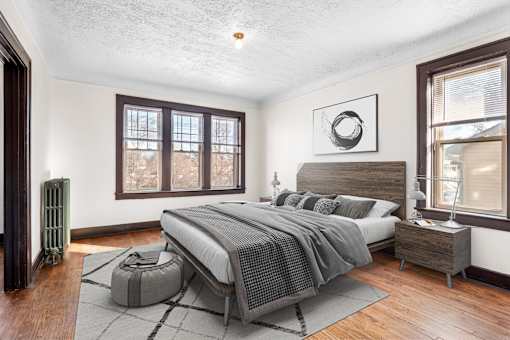 A bedroom with a large bed and a window.