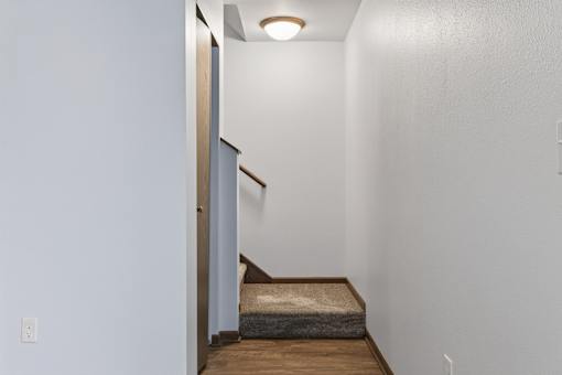 A small room with a bed and a light on the ceiling.