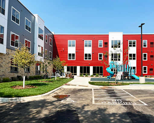 A red and white building with a playground in front.