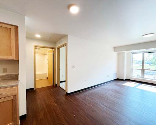 A room with wooden floors and white walls.
