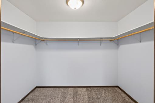 A room with a carpeted floor and a white wall.