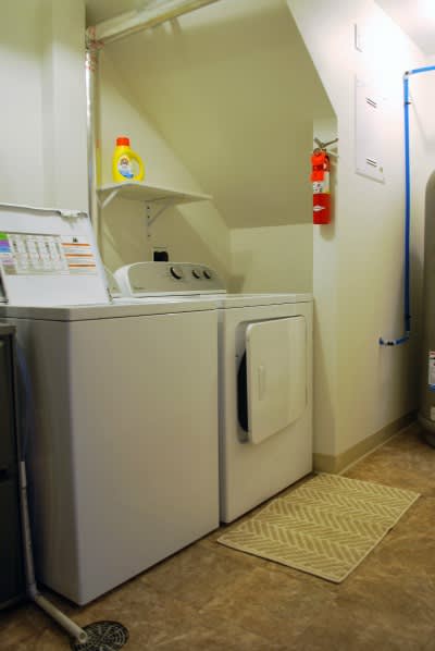 A small laundry room with a washer and dryer.