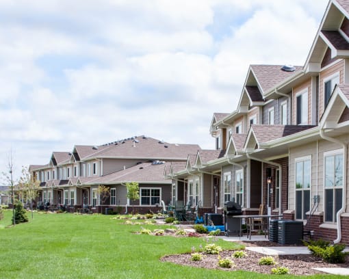 a row of houses on a grassy hill