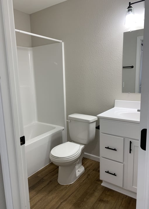 an empty bathroom with a toilet sink and bathtub