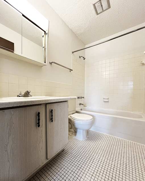 an empty bathroom with a toilet and a sink