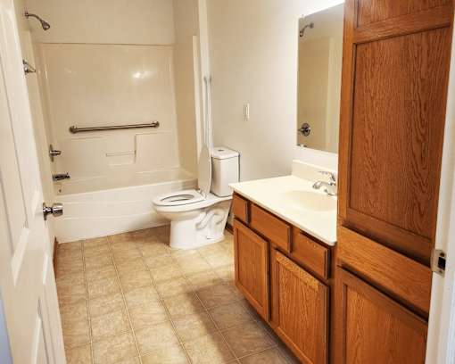 A bathroom with a toilet, sink, and bathtub.