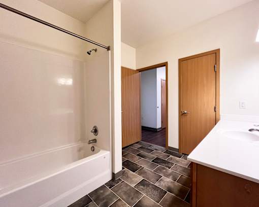 A bathroom with a white tub and a walk in shower.
