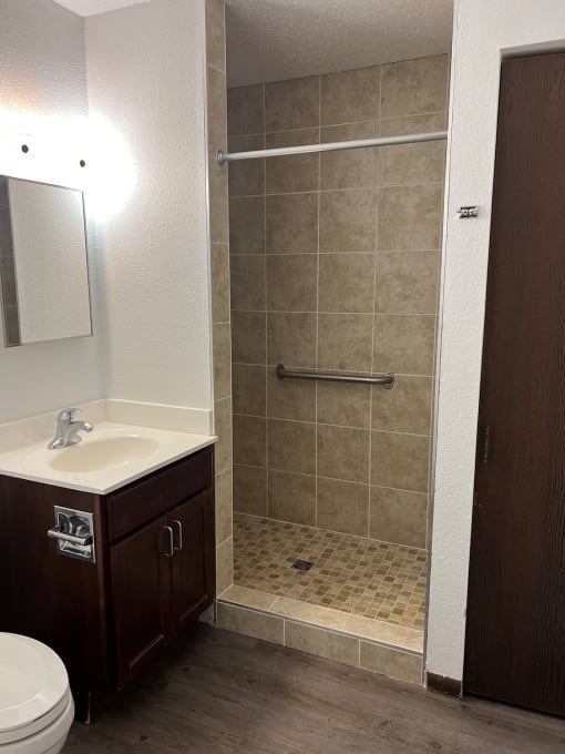 a small bathroom with a sink toilet and shower
