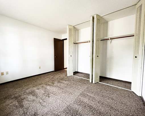an empty room with a carpeted floor and white walls
