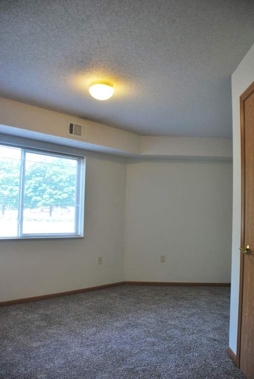 A room with a window and a door.