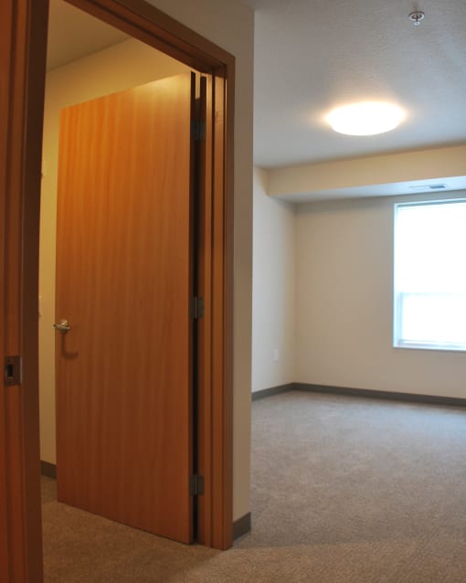 an empty living room with a wooden door