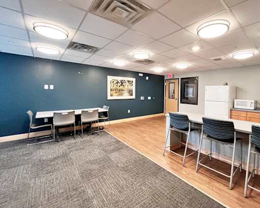 A conference room with a long table and chairs.
