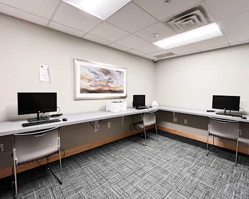 A room with two desks and two chairs.