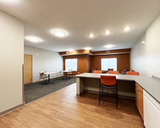 A room with a long table and chairs.