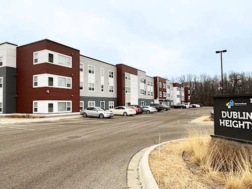 A parking lot in front of a building named Dublin Heights.