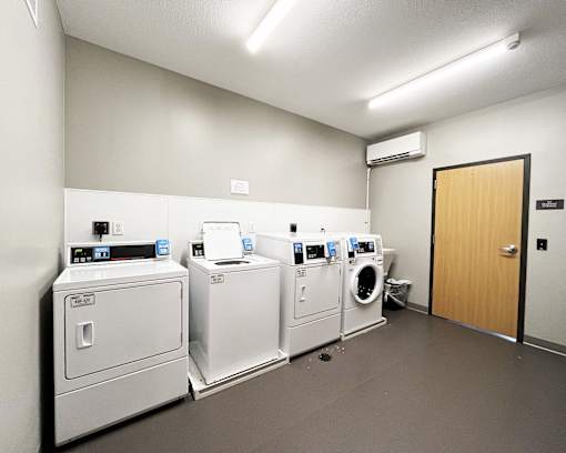 A row of washing machines in a laundromat.