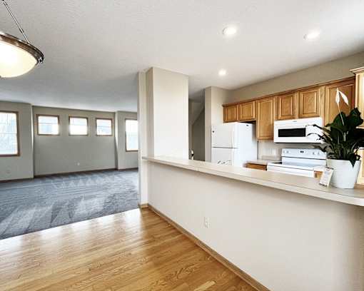 A kitchen with wooden cabinets and a white fridge.