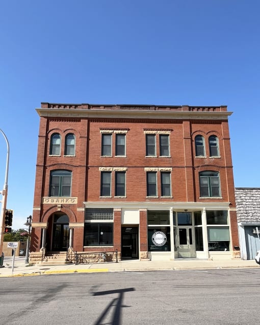 an old brick building on the corner of a city street