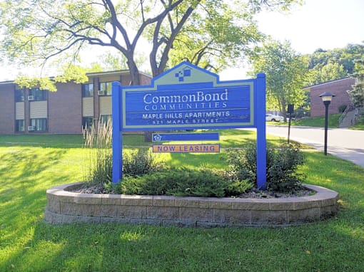 A sign for CommonBond Communities is displayed in front of a building.