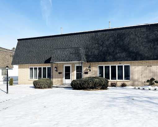 A building with a black roof and white doors and windows.
