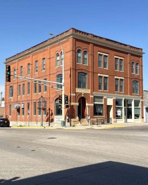 a large brick building on the corner of a city street